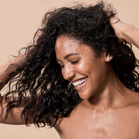 young brunette woman dancing and laughing