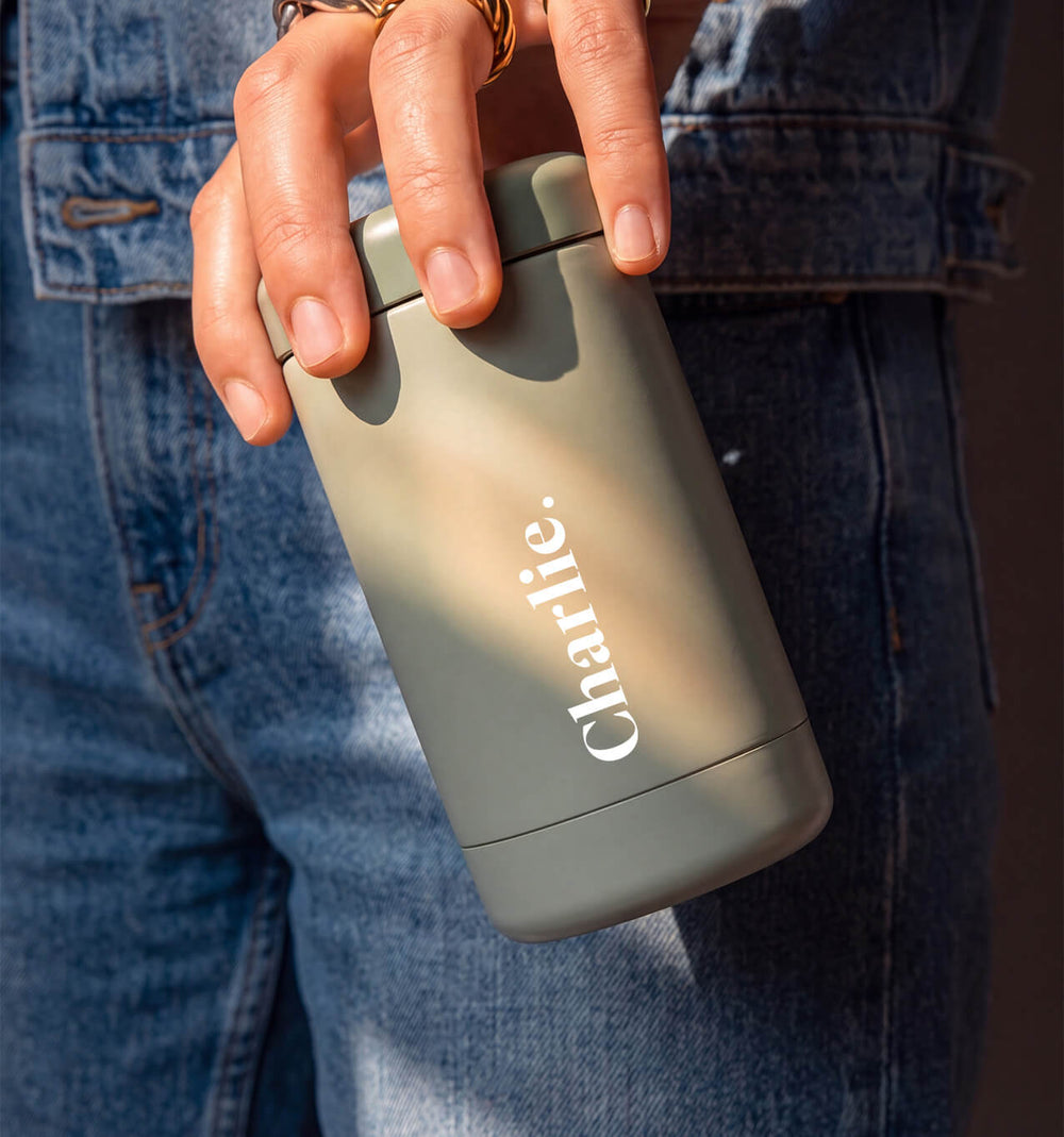 Beysis sage 340ml insulated stainless steel reusable coffee cup personalised with the name Charlie, held by the lid