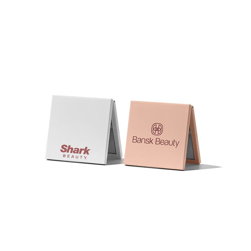 Beysis compact mirrors in two colours, each branded with a different company logo, standing open