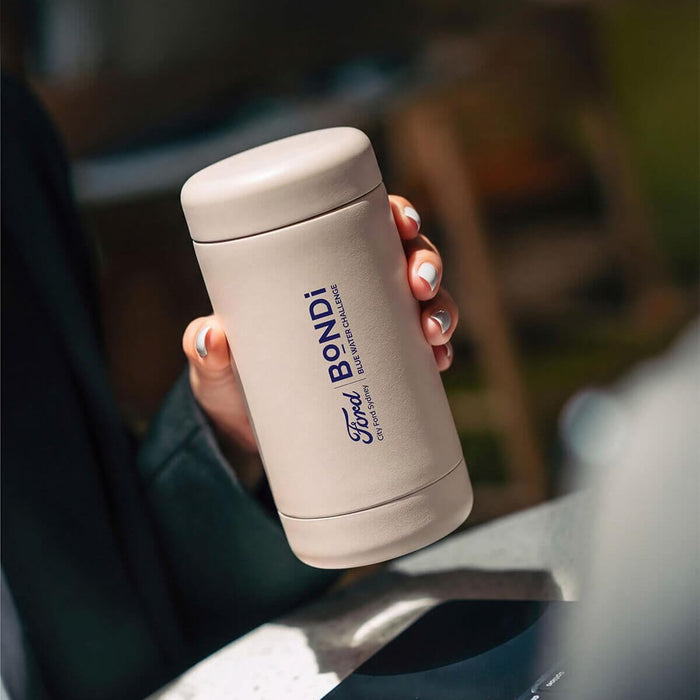 Beysis stone 340ml stainless steel reusable coffee cup branded with a company logo, held in a hand