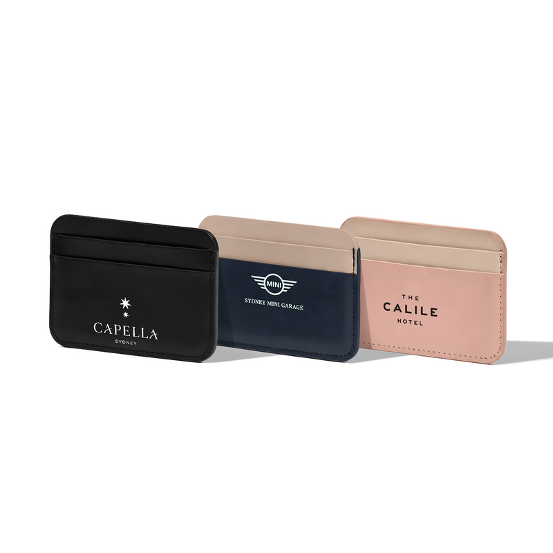 Beysis vegan leather card holders in black, navy and blush, each branded with a different company logo
