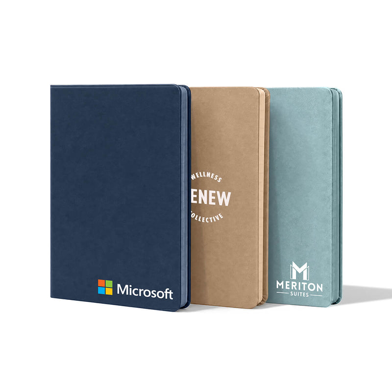 Beysis A5 vegan leather notebooks in navy blue, camel and seamist, each branded with a different company logo